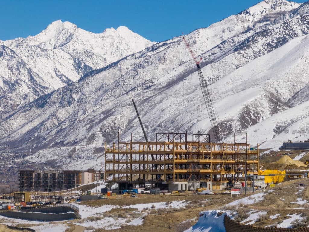 Baltic Pointe development under construction, with snowy mountains in the background