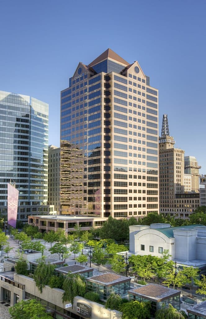 Exterior of One Utah Center and nearby buildings, daytime
