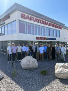 Exterior of Saratoga Storage at grand opening, with team of employees in front