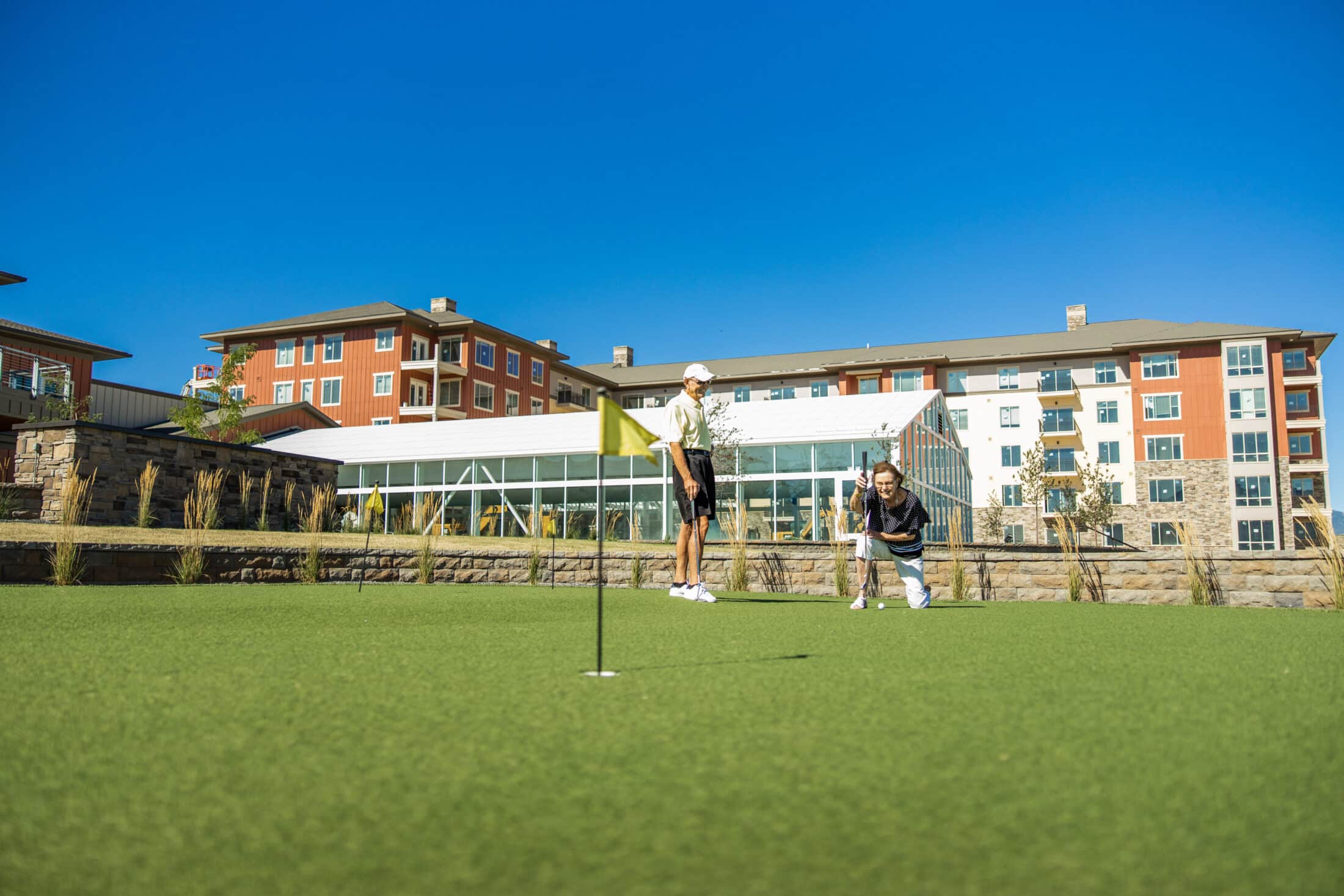 Exterior of Summit Vista, people on putting green