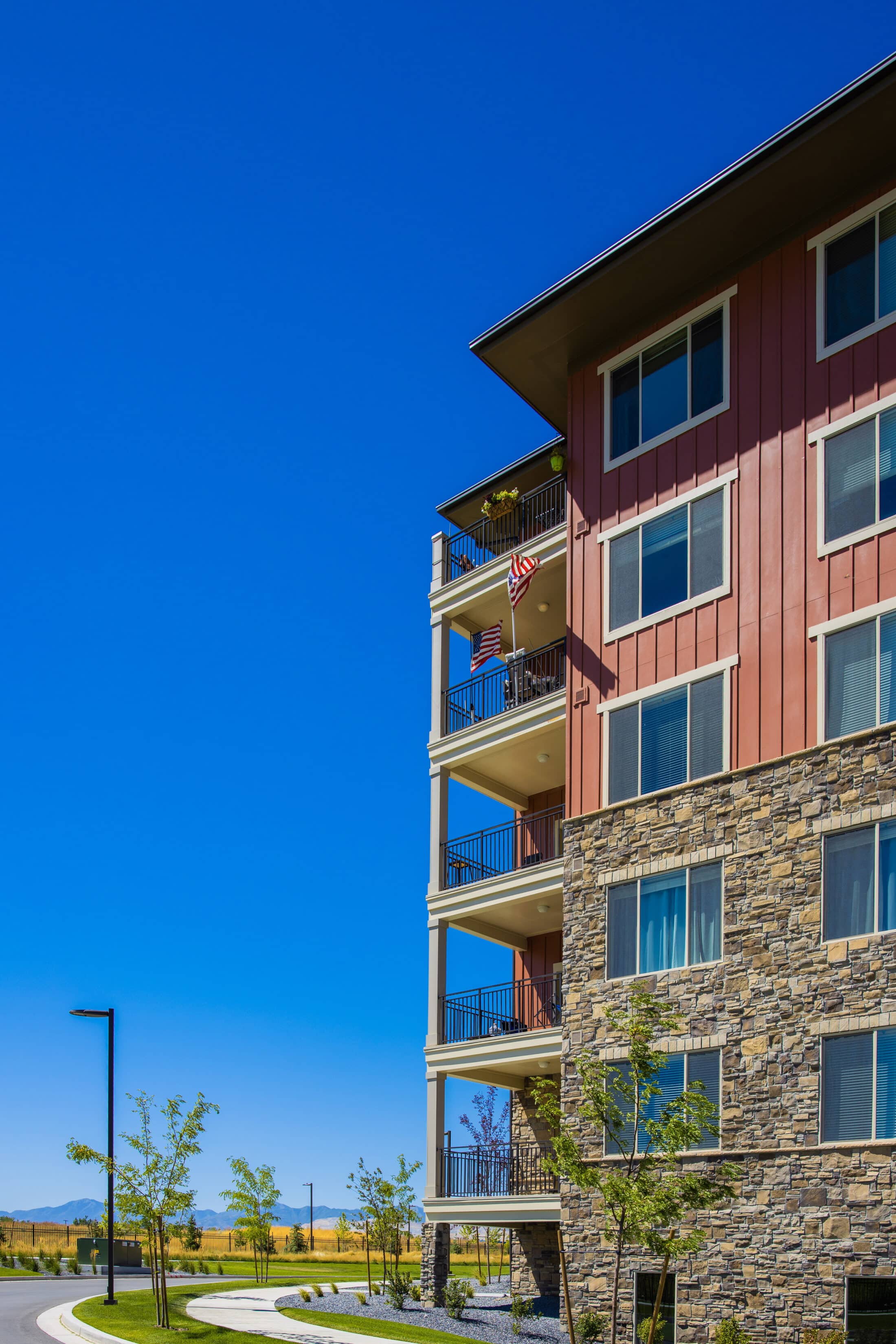 Exterior of Summit Vista, flag flying from a balcony unit