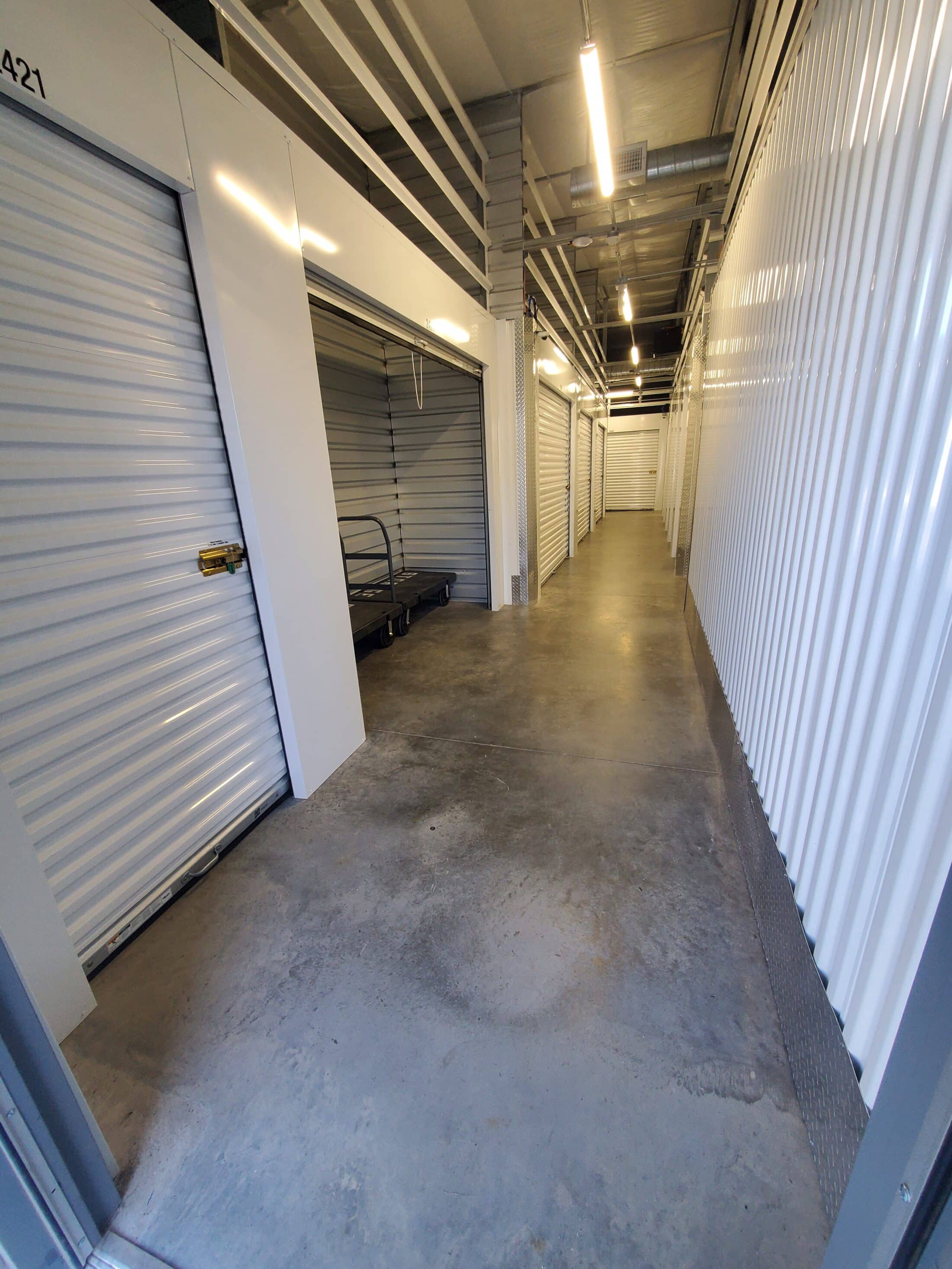 Interior of Storage unit climate controlled  building, white storage unit doors sown down hallway